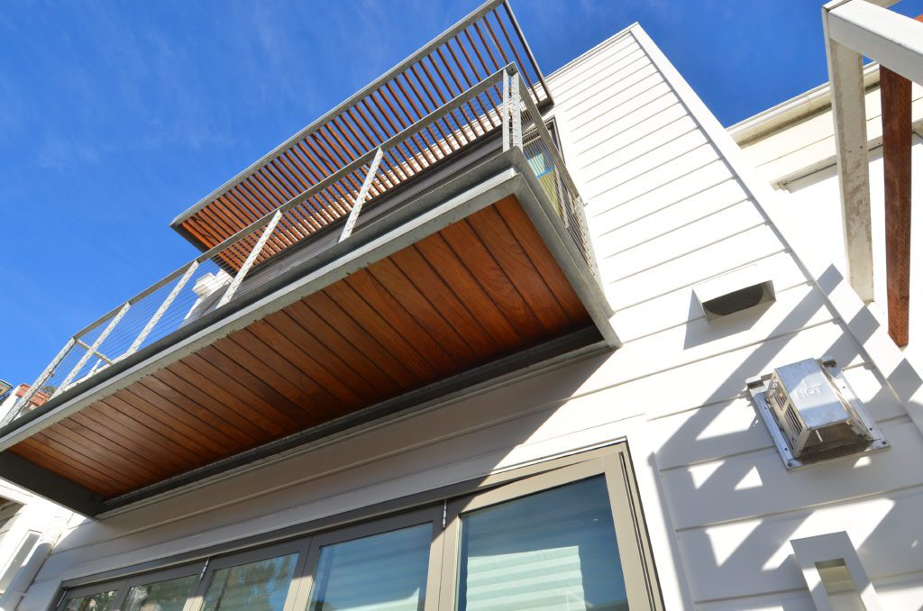 Home exterior horizontal siding with elevated upper floor deck