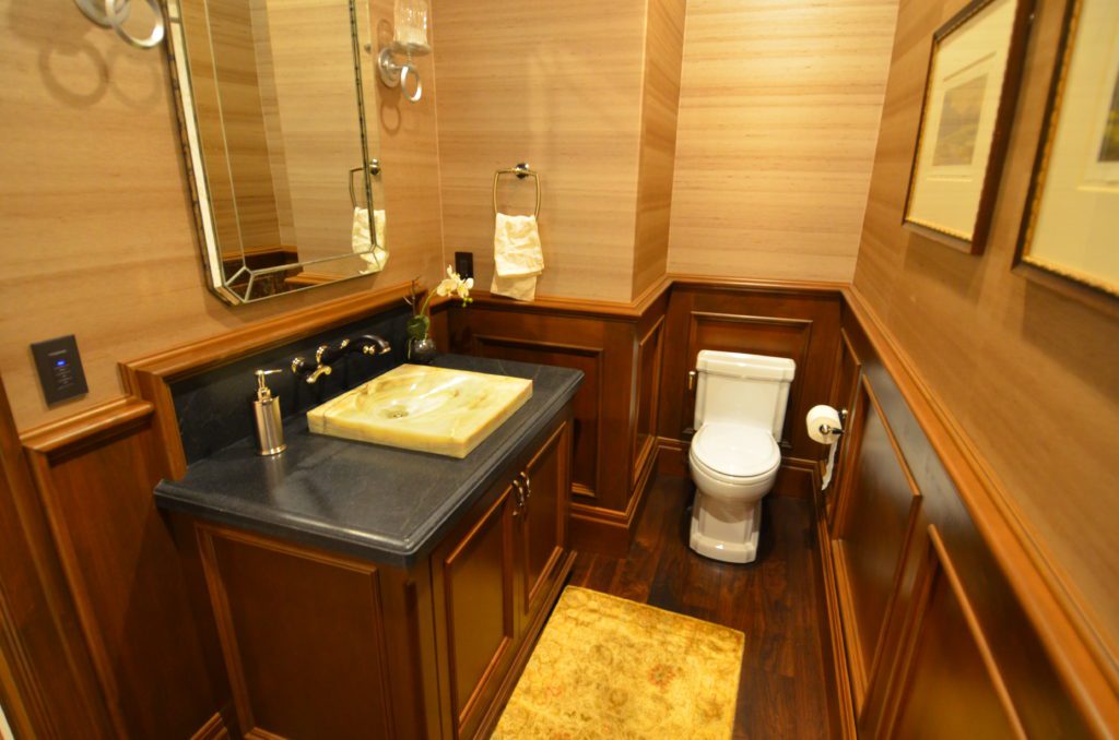 image showing wood cabinet and trim powder room